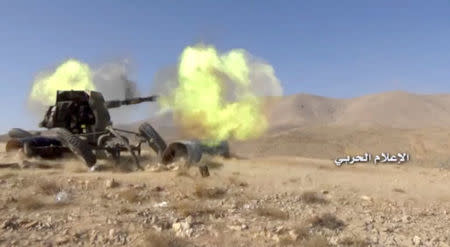 A still image taken on August 19, 2017 from a footage of Hezbollah military handout shows a Hezbollah artillery firing at western Qalamoun, Syria. Hezbollah Military Handout via Reuters TV.