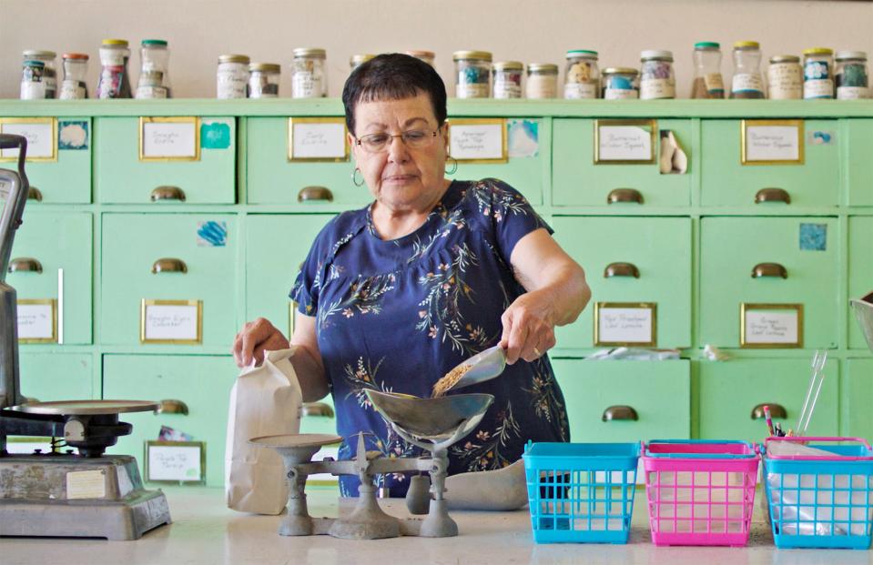 Sandy Cardinal weighs seeds for a customer at Williams Seed Store, 2154 U.S. 50 business, on the Mesa east of Pueblo.