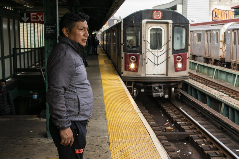 Ecuadorian immigrant Neptali Chiluisa waits for the subway as he returns from his temporary job in the borough of Bronx on Monday, Oct. 25, 2021, in New York. Chiluisa, who crossed the border in June in Arizona and was detained for a week with his 14-year-old son, acknowledges coming for economic reasons and wonders if he has any options for temporary legal status. (AP Photo/Eduardo Munoz Alvarez)