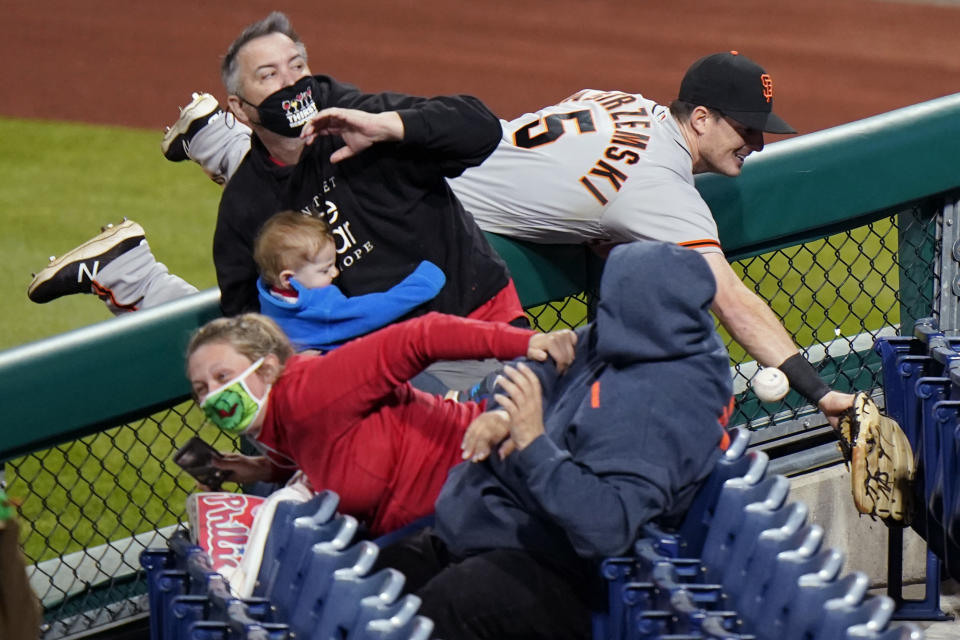 San Francisco Giants right fielder Mike Yastrzemski cannot reach a pop foul ball by Philadelphia Phillies' Rhys Hoskins during the ninth inning of a baseball game, Tuesday, April 20, 2021, in Philadelphia. (AP Photo/Matt Slocum)