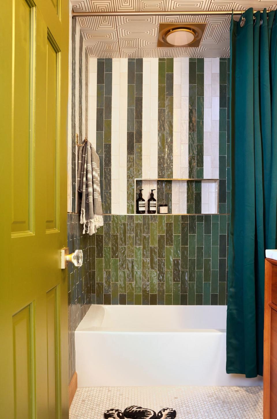 “The idea for the guest bathroom came from another garment from Brooke’s wardrobe—one with green and white stripes,” says David, whose firm used the same color combination for the wall tiles, while muting the ceiling with a monochrome wallpaper by Mitchell Black.