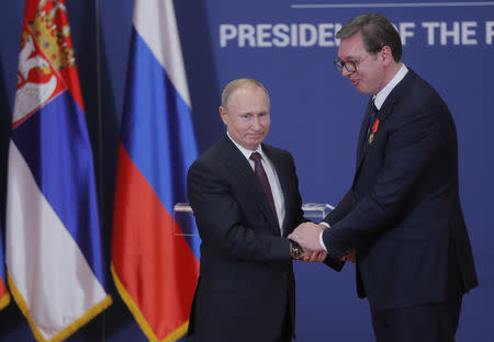 Russian President Vladimir Putin decorates Serbian President Alexandar Vucic with an order of Alexander Nevsky after their meeting in Belgrade, Serbia January 17, 2019. Maxim Shipenkov/Pool via REUTERS