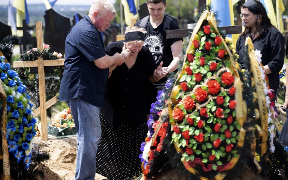 Families in mourning at a funeral ceremony held for two Ukrainian soldiers – First Lieutenant Mikita Gapic and Lieutenant Andrey Basikov, who lost their lives on the front line – at the military section of Cemetery 18 in Kharkiv - Metin Aktas/Anadolu Agency