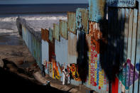 Workers paint the border wall between Mexico and U.S. in Tijuana, Mexico, December 7, 2018. REUTERS/Carlos Garcia Rawlins