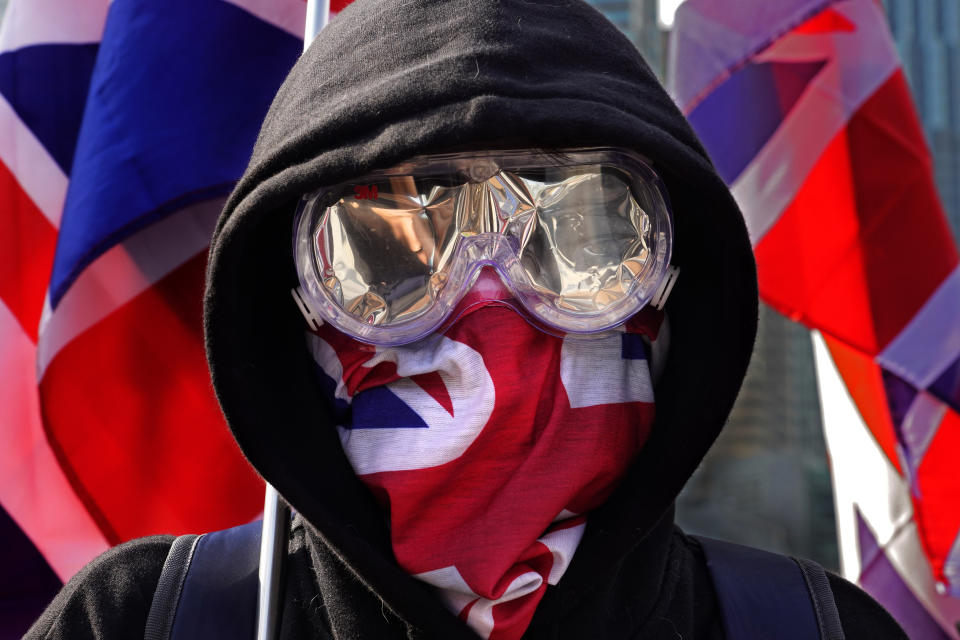 A protester wears a British flag mask during a rally in Hong Kong, Sunday, Jan. 12, 2020. More than a thousand people attended a Sunday rally in Hong Kong to urge people and governments abroad to support the territory's pro-democracy movement and oppose China's ruling Communist Party. (AP Photo/Vincent Yu)