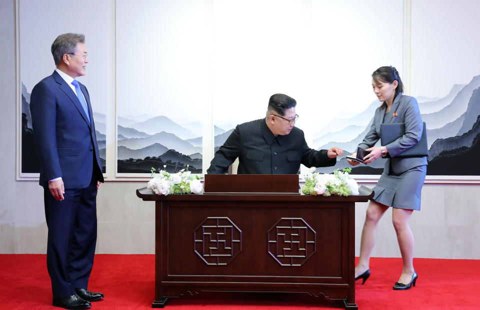 Kim signs the guest book&nbsp;at the Peace House in Panmunjom, South Korea.