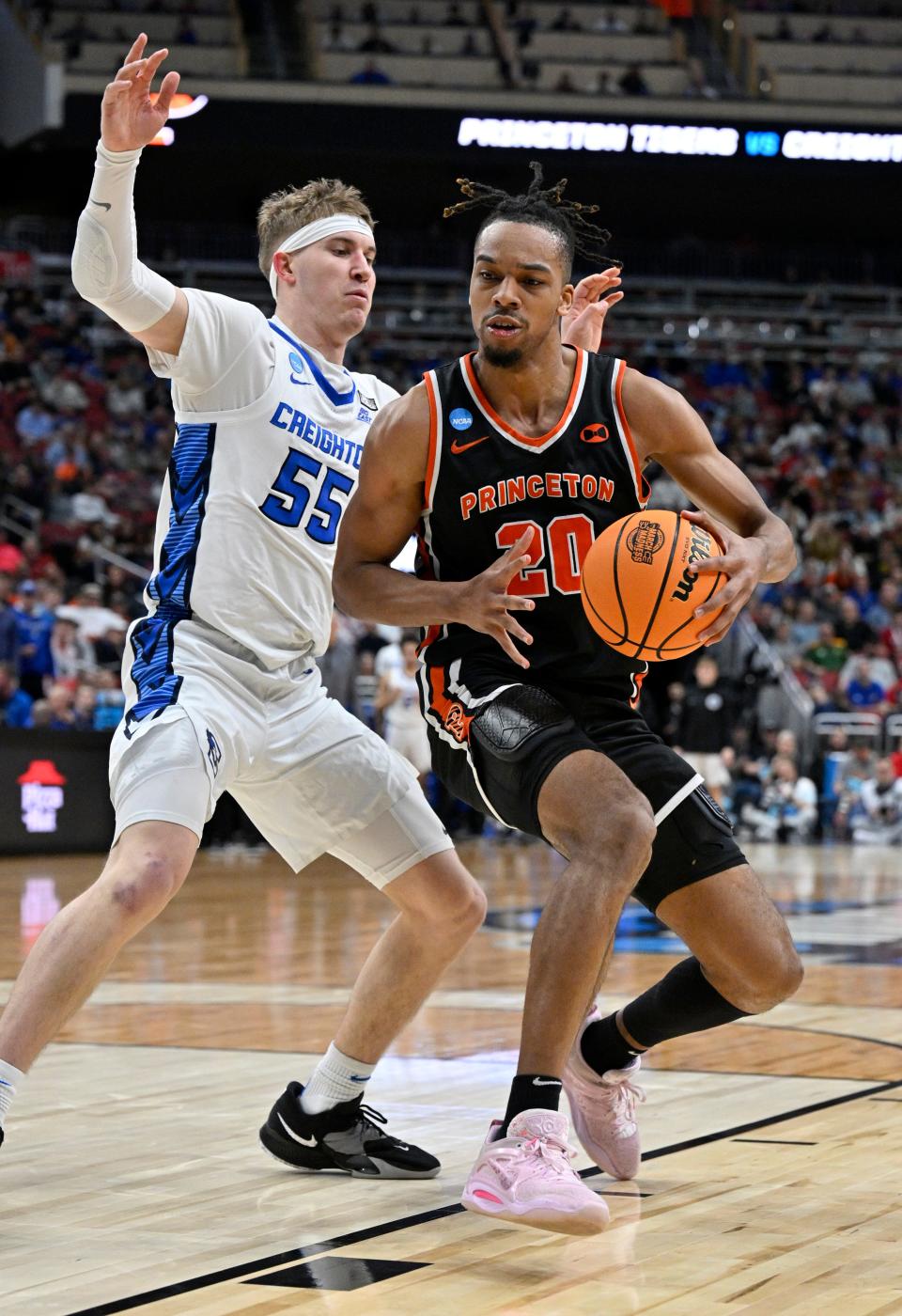 Mar 24, 2023; Louisville, KY, USA; Princeton Tigers forward Tosan Evbuomwan (20) dribbles against Creighton Bluejays guard Baylor Scheierman (55) during the second half of the NCAA tournament round of sixteen at KFC YUM! Center.