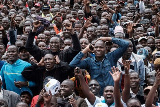 Fans watch Eliud Kipchoge's run on a giant screen in Eldoret