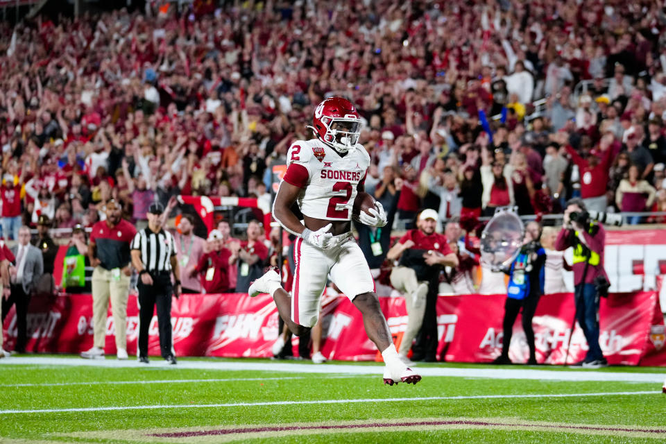 Dec 29, 2022; Orlando, Florida, USA; Oklahoma Sooners running back Jovantae Barnes (2) scores a touchdown against the Florida State Seminoles during the second half in the 2022 Cheez-It Bowl at Camping World Stadium. Rich Storry-USA TODAY Sports