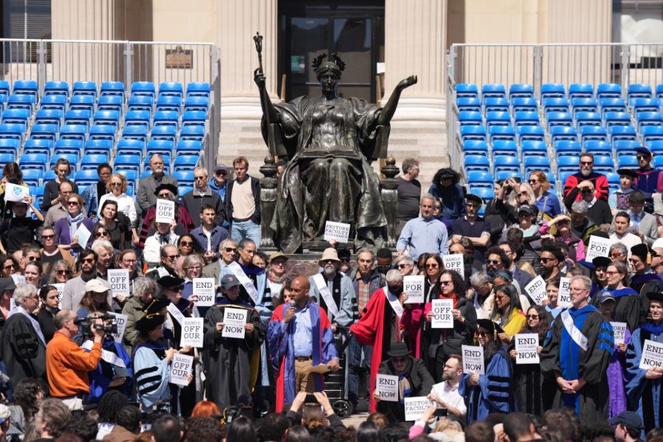 Columbia professors holding signs in support of the student protestors. James Keivom