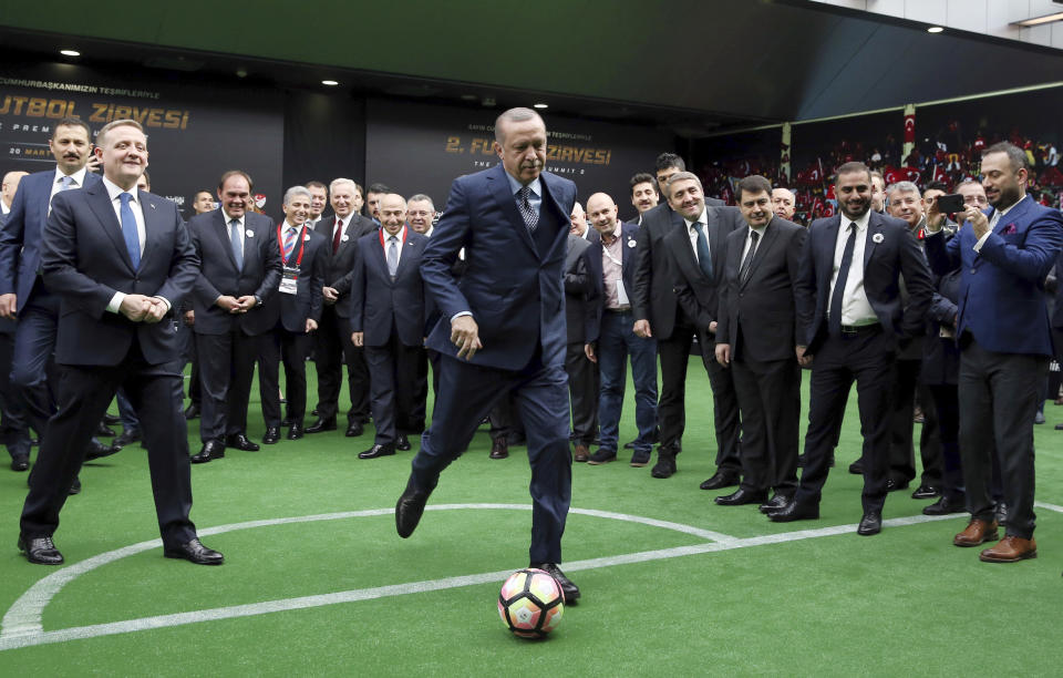 FILE - Turkey's President Recep Tayyip Erdogan kicks a ball during a soccer summit in Istanbul, on March 20, 2017. The 69-year-old who has served as prime minister since 2003 and president since 2014, started his career as a reformist who expanded rights and freedoms, allowing his majority-Muslim country to start European Union membership negotiations. (Yasin Bulbul/Turkish Presidency via AP, File)