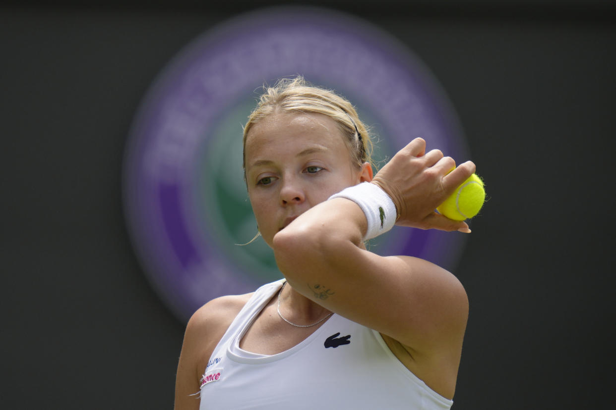 Estonia's Anett Kontaveit wipes her face after losing a point to Germany's Jule Niemeier during their singles tennis match on day three of the Wimbledon tennis championships in London, Wednesday, June 29, 2022. (AP Photo/Kirsty Wigglesworth)