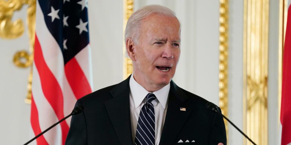 President Joe Biden speaks in front of a microphone