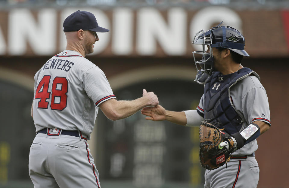 Atlanta Braves relief pitcher Jonny Venters is greeted by catcher Kurt Suzuki at the end of a baseball game against the San Francisco Giants Wednesday, Sept. 12, 2018, in San Francisco. Atlanta won the game 2-1. (AP Photo/Eric Risberg)