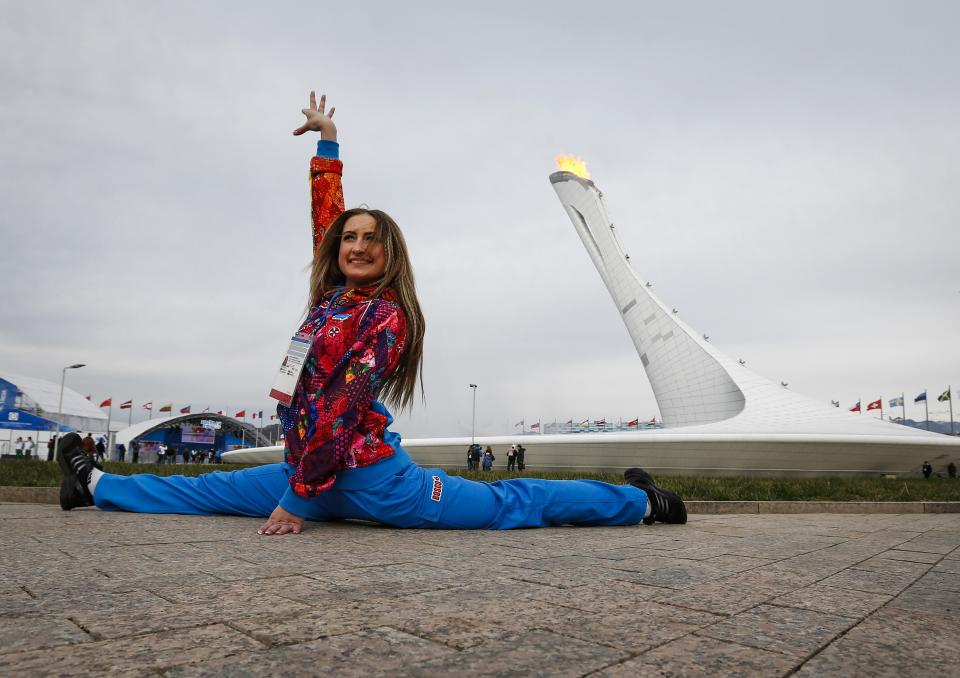 A woman posing for her friends does the splits in front of the Olympic Cauldron and flame during the Sochi 2014 Winter Olympics Games February 9, 2014. REUTERS/Shamil Zhumatov (RUSSIA - Tags: SPORT OLYMPICS TPX IMAGES OF THE DAY) ATTENTION EDITORS: PICTURE 24 OF 25 FOR PACKAGE 'SOCHI - EDITOR'S CHOICE' TO FIND ALL IMAGES SEARCH 'EDITOR'S CHOICE - 09 FEBRUARY 2014'