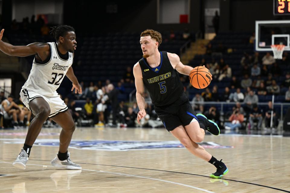 Christian Ray tries to maneuver past Charles Thompson in Delaware's 86-60 CAA quarterfinal loss to Towson Sunday night in Washington.