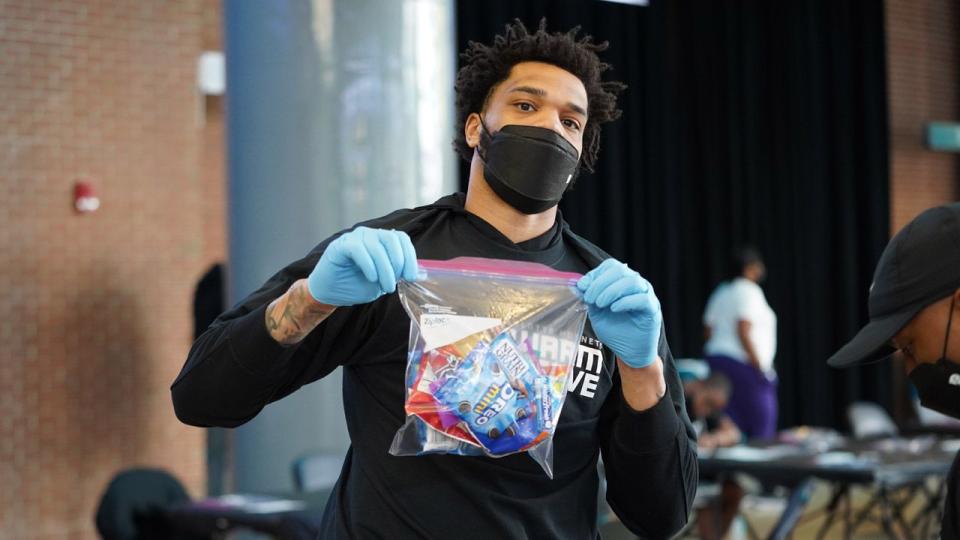 Miles Bridges of the Charlotte Hornets helps prepare care kits for U.S. troops.