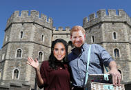 <p>Esta pareja con máscaras de los novios posa delante del Castillo de Windsor. (Foto: Marko Djurica / Reuters). </p>