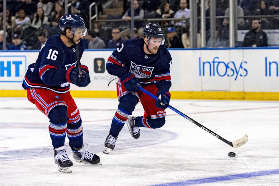 New York Rangers left wing Alexis Lafreniere (13) advances the puck ahead of Tampa Bay Lightning left wing Brandon Hagel (38) during the first period of an NHL hockey game on Wednesday, Feb. 7, 2024 in New York. (AP Photo/Peter K. Afriyie)