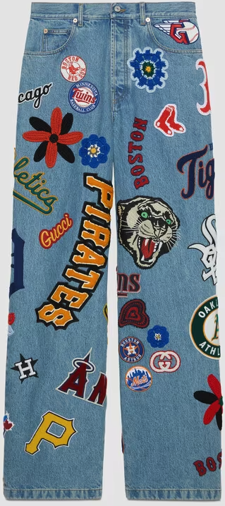 denim jeans with sewn patches of baseball team mascots and logos