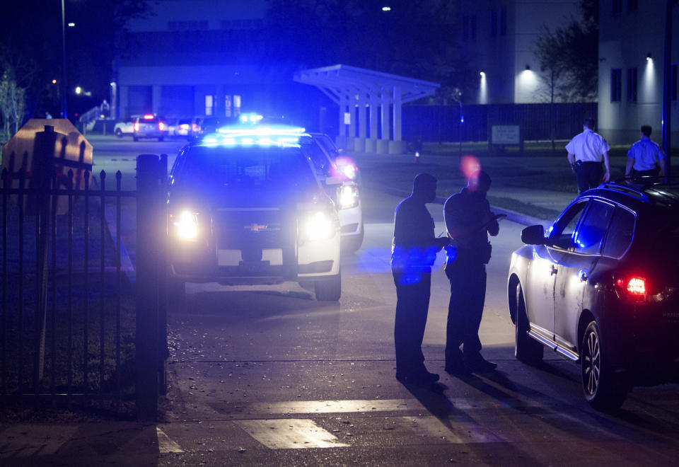 New Orleans police investigate after the fatal shooting of a police officer at George Washington Carver High School where a basketball game was being played, Friday, Feb. 26, 2021, in New Orleans. (Max Becherer/The Times-Picayune/The New Orleans Advocate via AP)