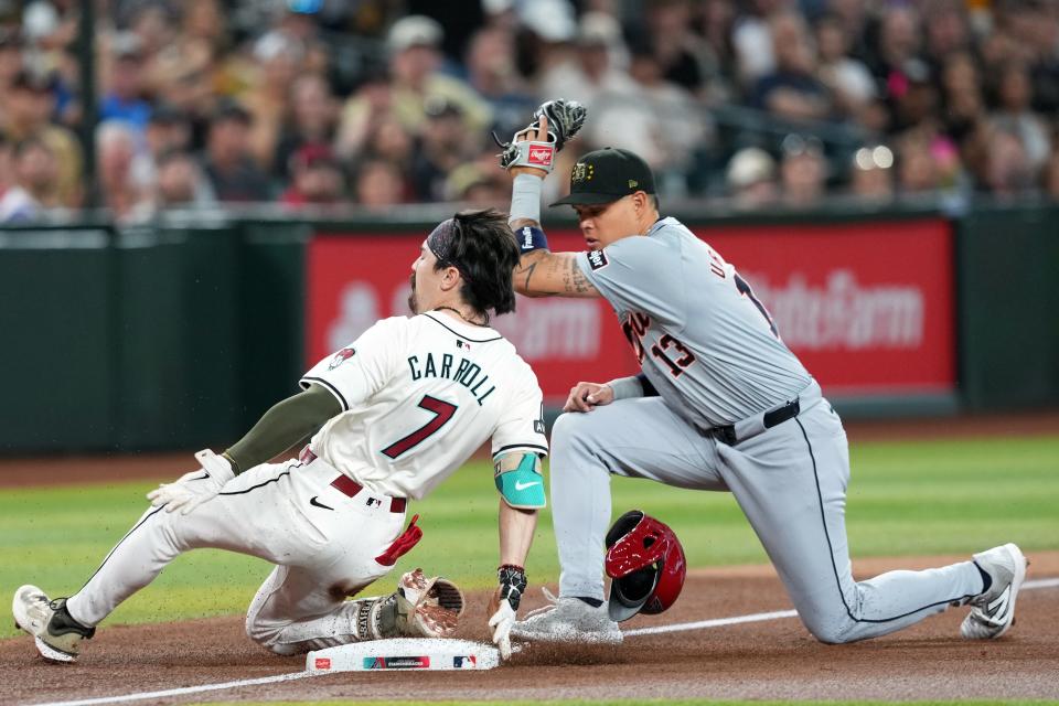 Arizona Diamondbacks outfielder Corbin Carroll (7) beats a throw to Detroit Tigers third base Gio Urshela (13) to reach safely for a triple during the first inning at Chase Field on Sunday, May 19, 2024.