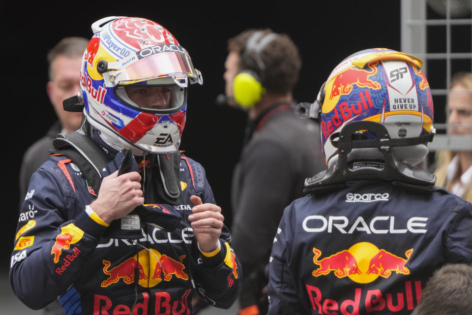 Sprint race winner Red Bull driver Max Verstappen, left, of the Netherlands gestures to third placed teammate Sergio Perez of Mexico at the Chinese Formula One Grand Prix at the Shanghai International Circuit, Shanghai, China, Saturday, April 20, 2024. (AP Photo/Andy Wong)