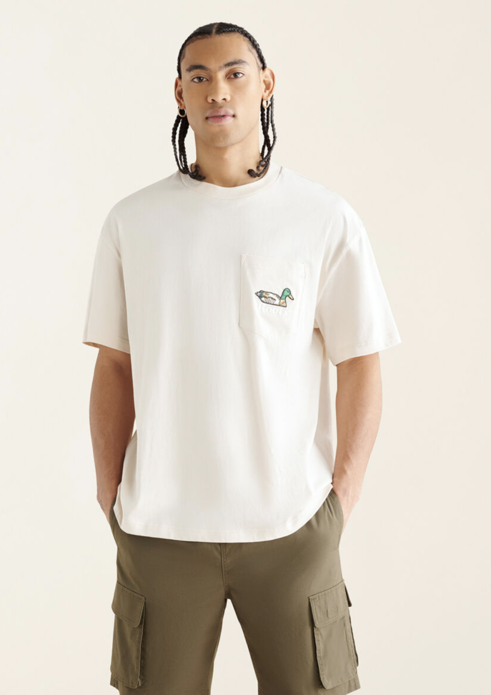 man wearing white t-shirt and green cargo shorts, Men's Pond Life Relaxed T-Shirt (photo via Roots)