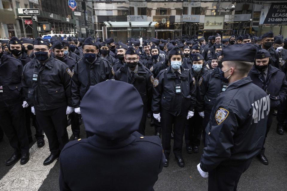 New York Police officers gather along Fifth Avenue outside St. Patrick's Cathedral for Officer Wilbert Mora's funeral, Wednesday, Feb. 2, 2022, in New York. Mora was shot along with Officer Jason Rivera on Jan. 22 while responding to a call about a domestic argument in an apartment. (AP Photo/Yuki Iwamura)