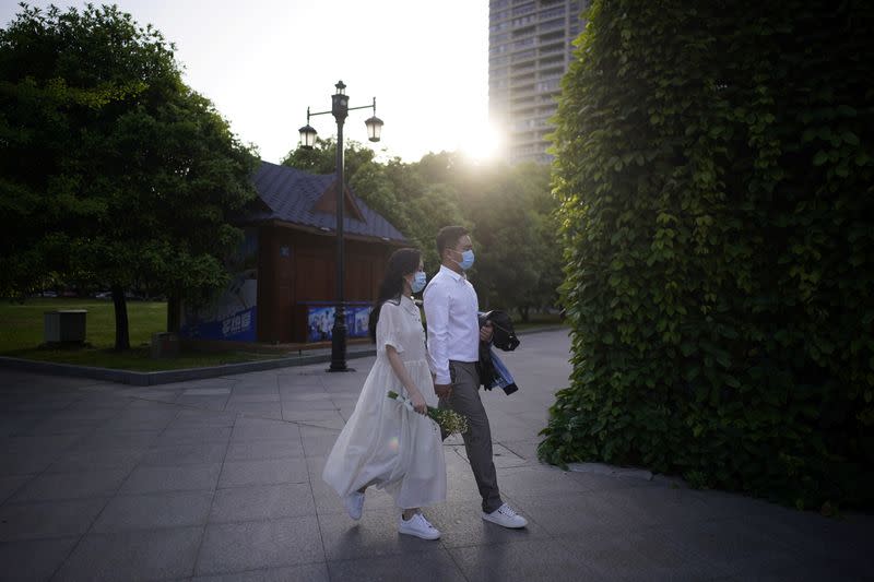 Peng Jing, 24, and Yao Bin, 28, attend their wedding photography shoot after the lockdown was lifted in Wuhan