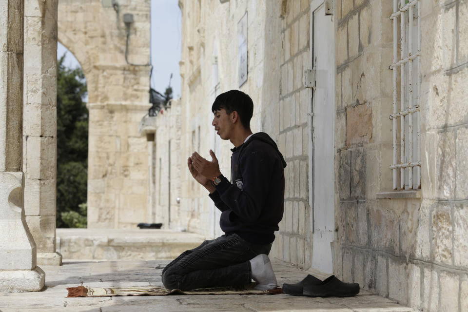 A man takes part in the last Friday prayers of the Muslim holy month of Ramadan at the Dome of the Rock Mosque in the Al Aqsa Mosque compound in the Old City of Jerusalem, Jerusalem, Friday, May 7, 2021. (AP Photo/Mahmoud Illean)