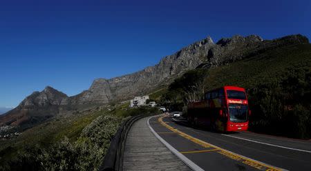 FILE PHOTO: A tour bus carries visitors to Table Mountain in Cape Town, South Africa, August 5, 2017. REUTERS/Mike Hutchings/File Photo