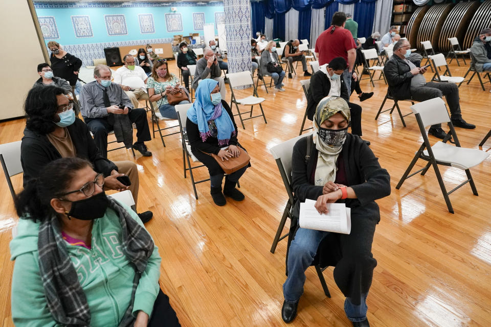 Patients wait in the observation area after being inoculated with the Johnson & Johnson COVID-19 vaccine at a pop up vaccination site inside the Albanian Islamic Cultural Center, Thursday, April 8, 2021, in the Staten Island borough of New York. Ahead of Ramadan, Islamic leaders are using social media, virtual town halls and face-to-face discussions to spread the word that it’s acceptable for Muslims to be vaccinated during daily fasting that happens during the holy month. (AP Photo/Mary Altaffer)