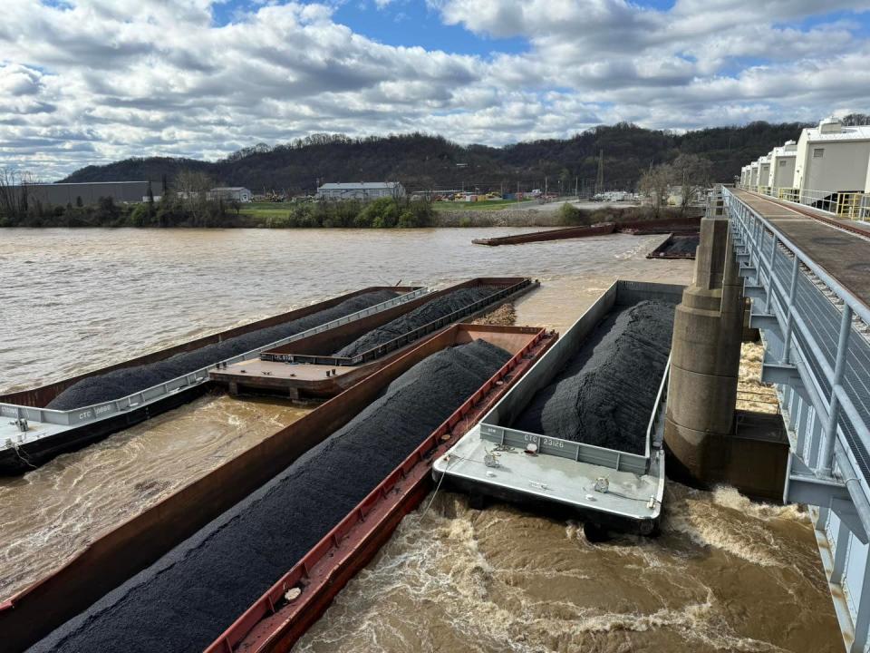 The force of the water slammed one of the barges against the cement pier so hard that it bent.