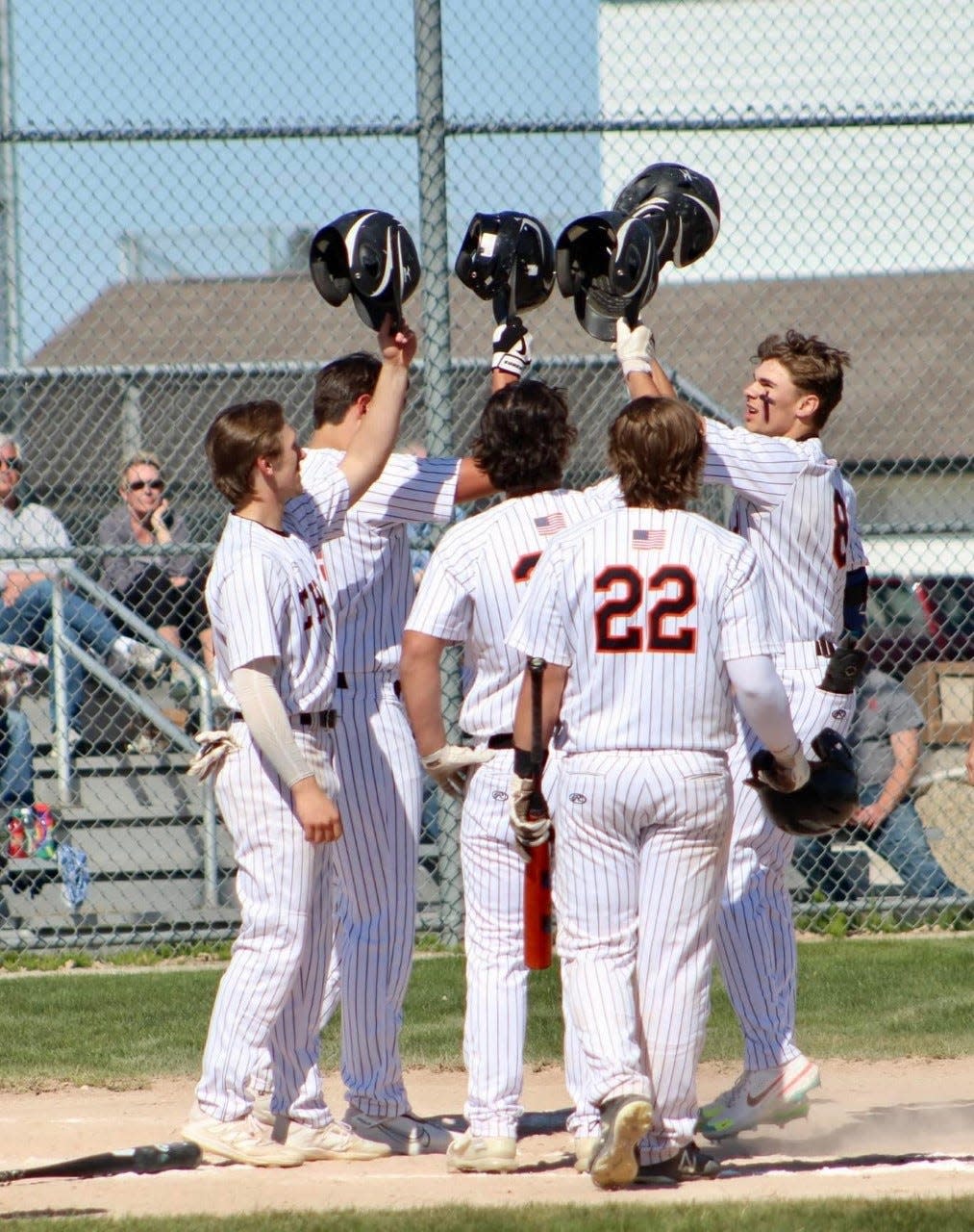 Cheboygan senior Daniel Wilcome (far right) celebrates with teammates after hitting a grand slam during game one of a baseball doubleheader against Inland Lakes on Monday.