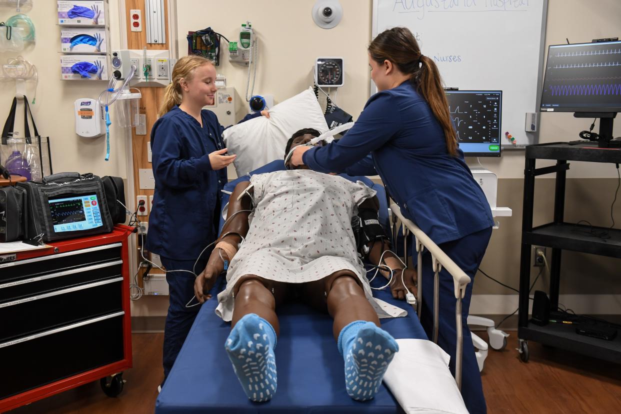 Senior nursing students Erika Hoff and Claire Fischer practice giving care to a mannequin patient on Thursday, Nov. 2, 2023 at Augustana University in Sioux Falls, South Dakota.