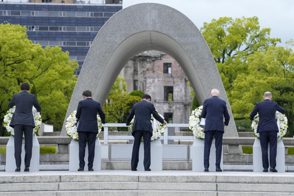 Prime Minister Justin Trudeau of Canada, left, President Emmanuel Macron of France, Prime Minister Fumio Kishida of Japan, U.S. President Joe Biden and Chancellor Olaf Scholz, right, of Germany lay a wreath at the Hiroshima Peace Memorial Park in Hiroshima, Japan, Friday, May 19, 2023, during the G7 Summit. (AP Photo/Susan Walsh,Pool)