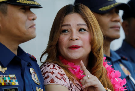 Barangay Bagong Silangan district chief Crisell Beltran talks to a police officer during a flag-raising ceremony at Batasan Police Station 6 in Quezon City, Metro Manila, Philippines December 4, 2017. REUTERS/Erik De Castro