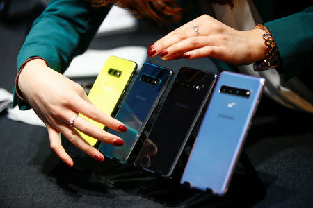 A Samsung employee arranges the new Samsung Galaxy S10e, S10, S10+ and the Samsung Galaxy S10 5G smartphones at a press event in London, Britain February 20, 2019. REUTERS/Henry Nicholls