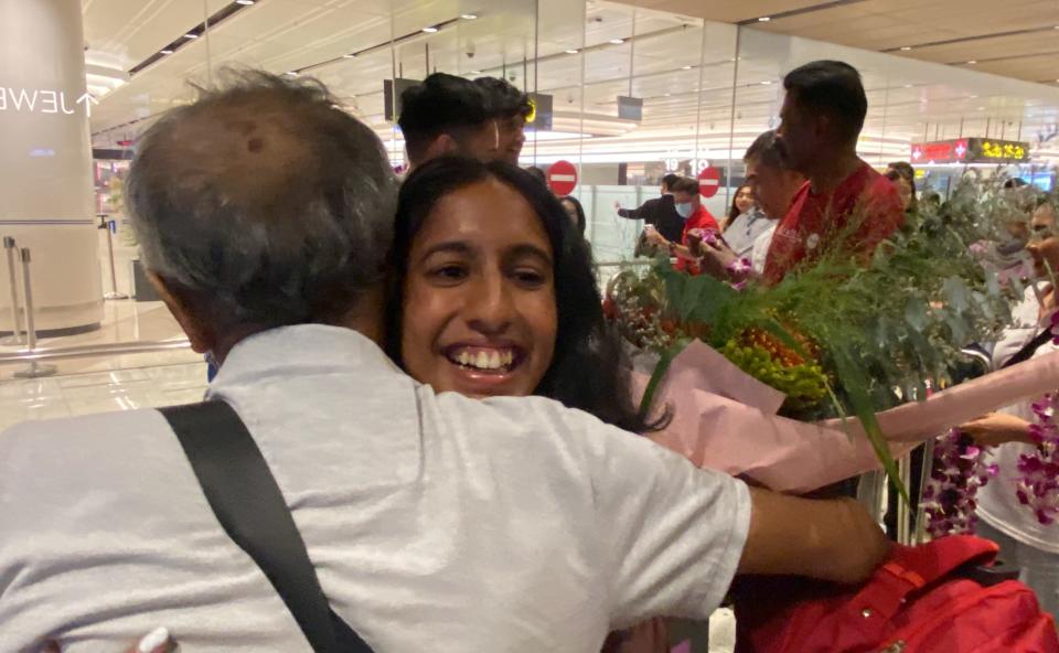 Singapore sprinter Shanti Pereira being embraced by her relative as she returns from the 2023 Hangzhou Asian Games with a gold and a silver medal. (PHOTO: Chia Han Keong/Yahoo News Singapore)