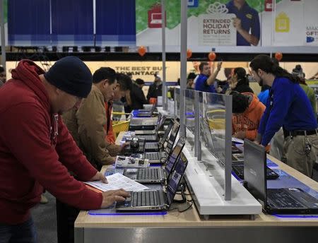 Shoppers look at laptop computers at a Best Buy store on the shopping day dubbed "Black Friday" in Framingham, Massachusetts November 25, 2011. REUTERS/Adam Hunger