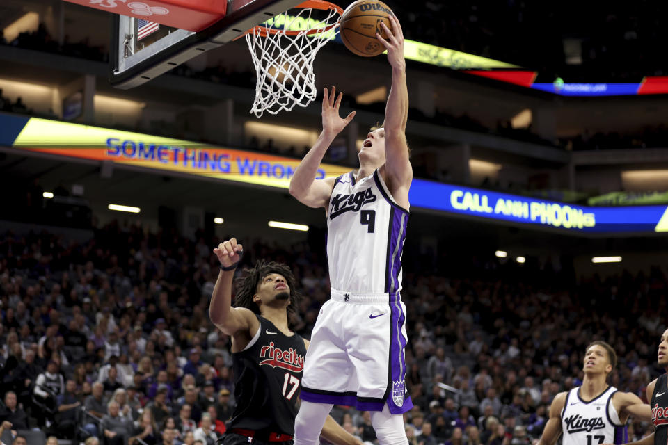 Sacramento Kings guard Kevin Huerter (9) shoots against Portland Trail Blazers guard Shaedon Sharpe (17) during the second half of an NBA basketball game in Sacramento, Calif, Wednesday, Nov. 8, 2023. (AP Photo/Jed Jacobsohn)