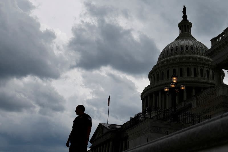 FILE PHOTO: Storm clouds pass over the U.S. Capitol in Washington