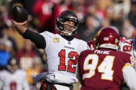 Tampa Bay Buccaneers quarterback Tom Brady (12) throws under pressure from Washington Football Team defensive tackle Daron Payne (94) during the first half of an NFL football game Sunday, Nov. 14, 2021, in Landover, Md. (AP Photo/Nick Wass)