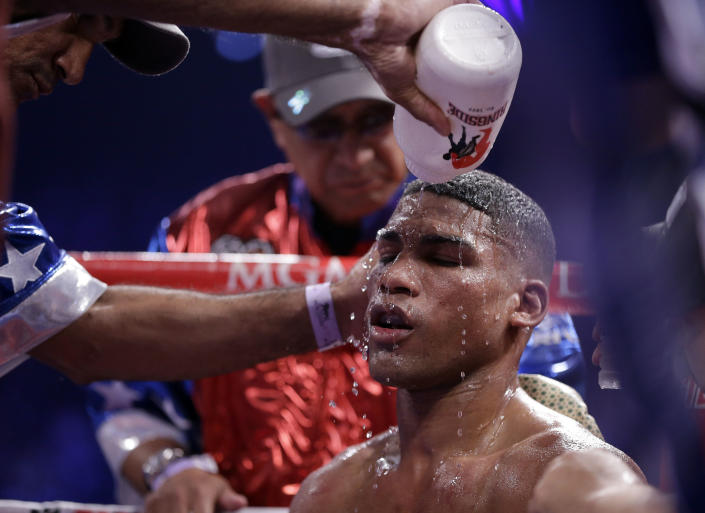 Yuriorkis Gamboa, from Miami, Fla., is cooled down in his corner during his WBA interim super featherweight title fight against Michael Farenas, from the Philippines, Saturday, Dec. 8, 2012, in Las Vegas. (AP Photo/Julie Jacobson)