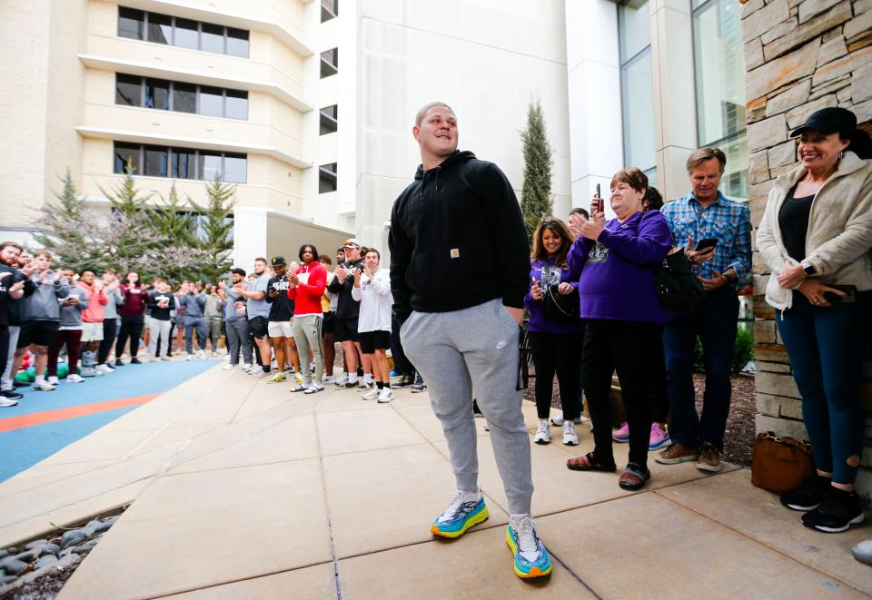 Connor Lair reacts to his teammates, friends and family members as they cheer him on after he rang the bell outside Mercy Children's Hospital on Tuesday, Feb. 6, 2024, symbolizing that he is finished with chemotherapy treatment for Hodgkins Lymphoma that he was diagnosed with in the fall of 2023.