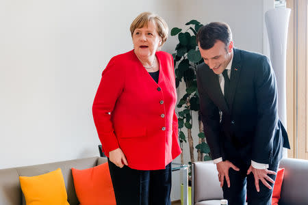 French President Emmanuel Macron and German Chancellor Angela Merkel meet on the sidelines of an EU summit in Brussels, Belgium March 21, 2019. Geert Vanden Wijngaert/Pool via Reuters