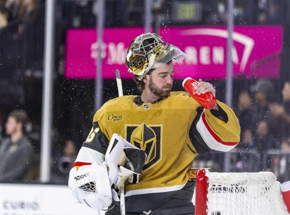 Vegas Golden Knights goaltender Logan Thompson (36) cools off during a timeout in the first period of the team's NHL hockey game against the St. Louis Blues on Friday, Dec. 23, 2022, in Las Vegas. (AP Photo/L.E. Baskow)