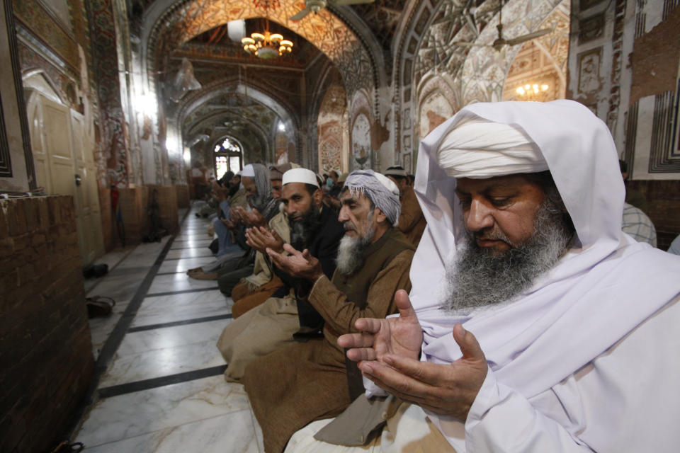 Pakistani worshippers attend a Friday prayers in Peshawar, Pakistan, Friday, March 27, 2020. Authorities imposed nation-wide lockdown and appealed to people to avoid public gatherings as a preventive measure to contain the spread of coronavirus. The virus causes mild or moderate symptoms for most people, but for some, especially older adults and people with existing health problems, it can cause more severe illness or death.(AP Photo/Muhammad Sajjad)