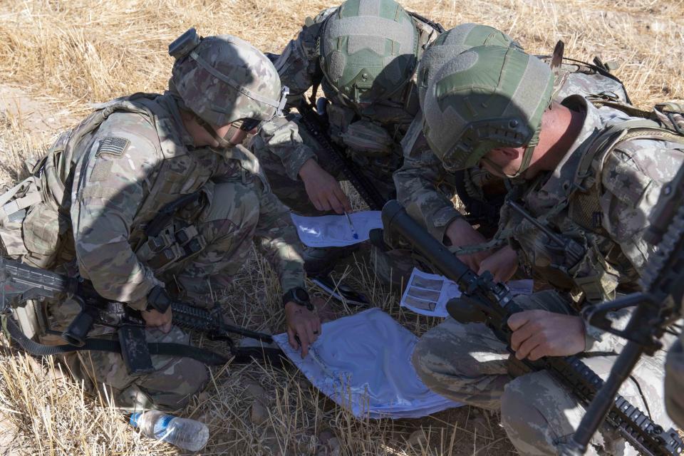 In this In this Sept. 24, 2019, photo, released by the U.S. Army, U.S. and Turkish military forces go over a map in preparation of their second joint ground patrol inside the so-called "safe zone" in northeast Syria near the border with Turkey. (U.S. Army photo by Staff Sgt. Andrew Goedl via AP)